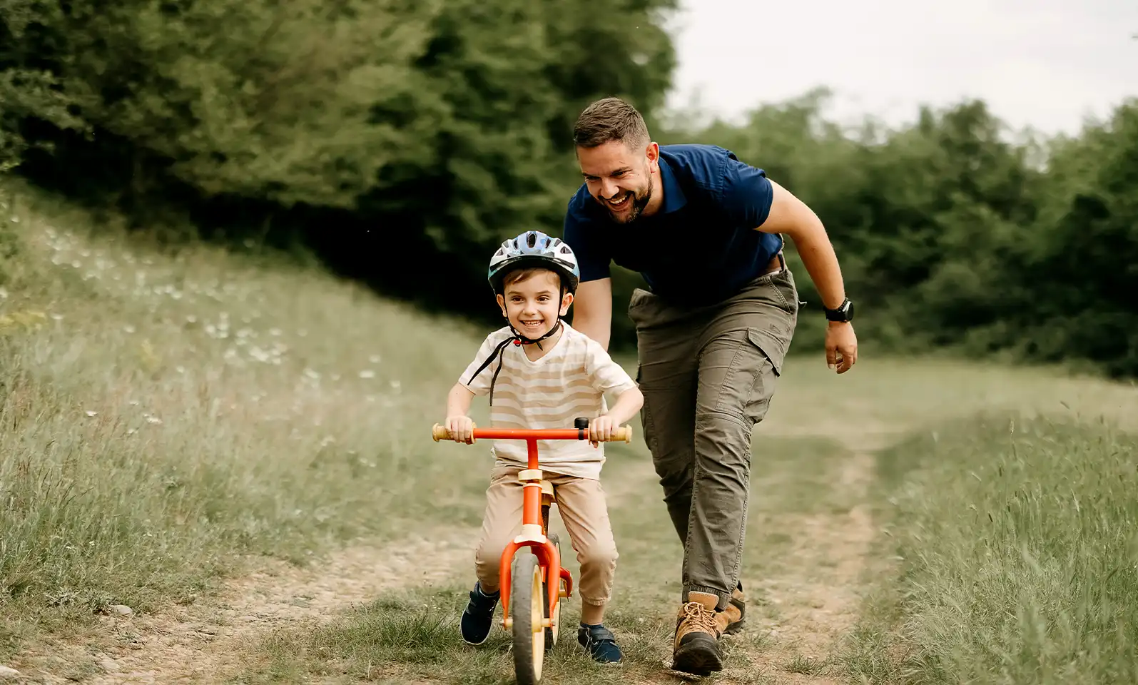 Father teaches son to ride a bike