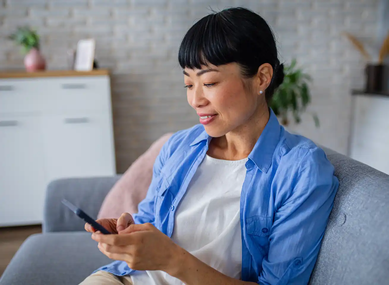 Woman on the phone at home with her laptop