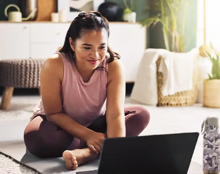 Woman reviewing her health plan on a laptop at home