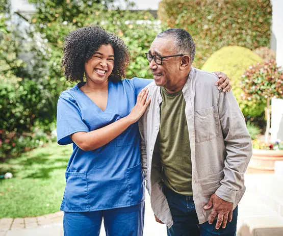 Hospital staff helps senior.