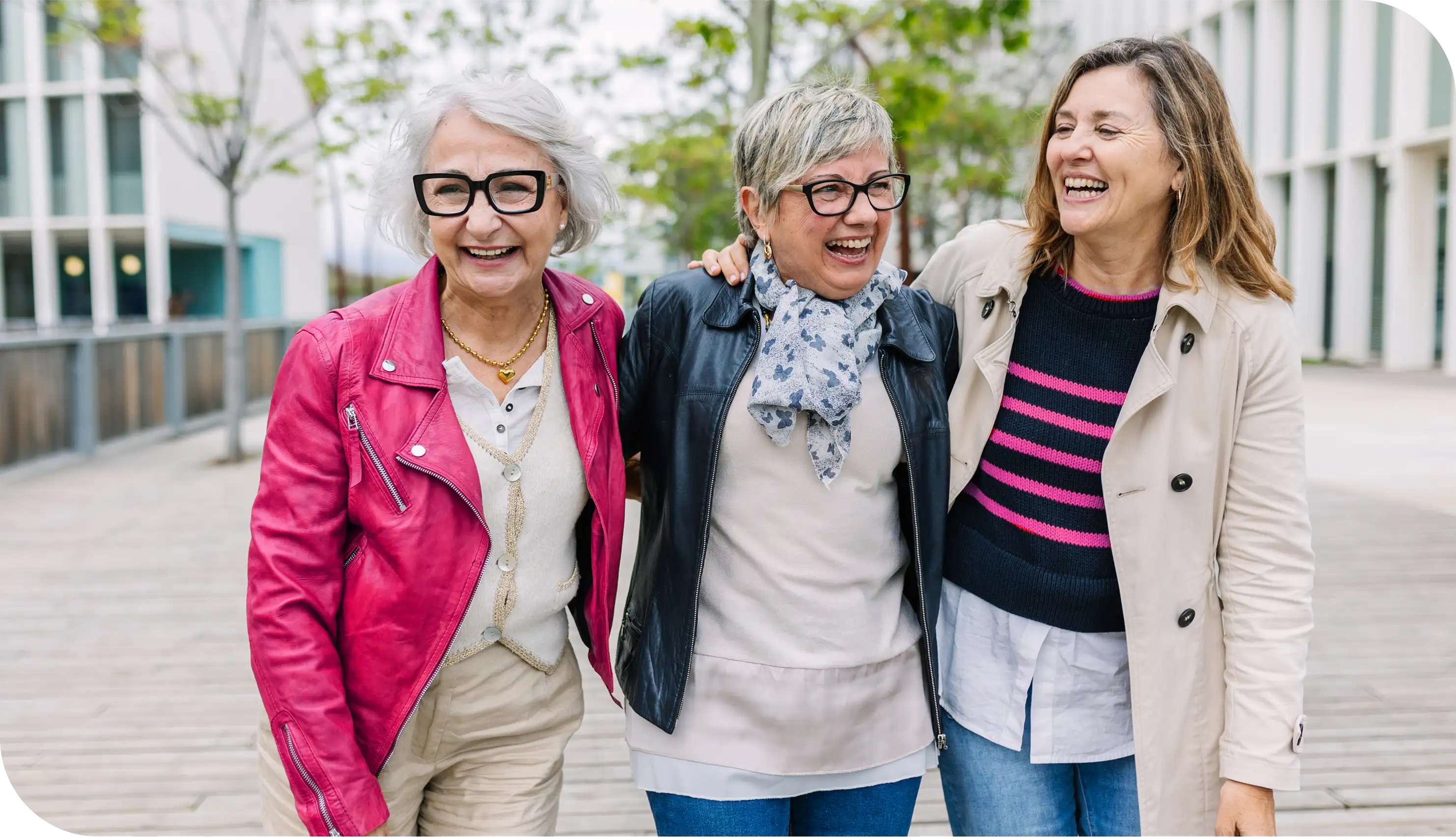 Group of women walking outdoors and laughing, symbolizing friendship, retirement lifestyle, and Medicare healthcare coverage support.