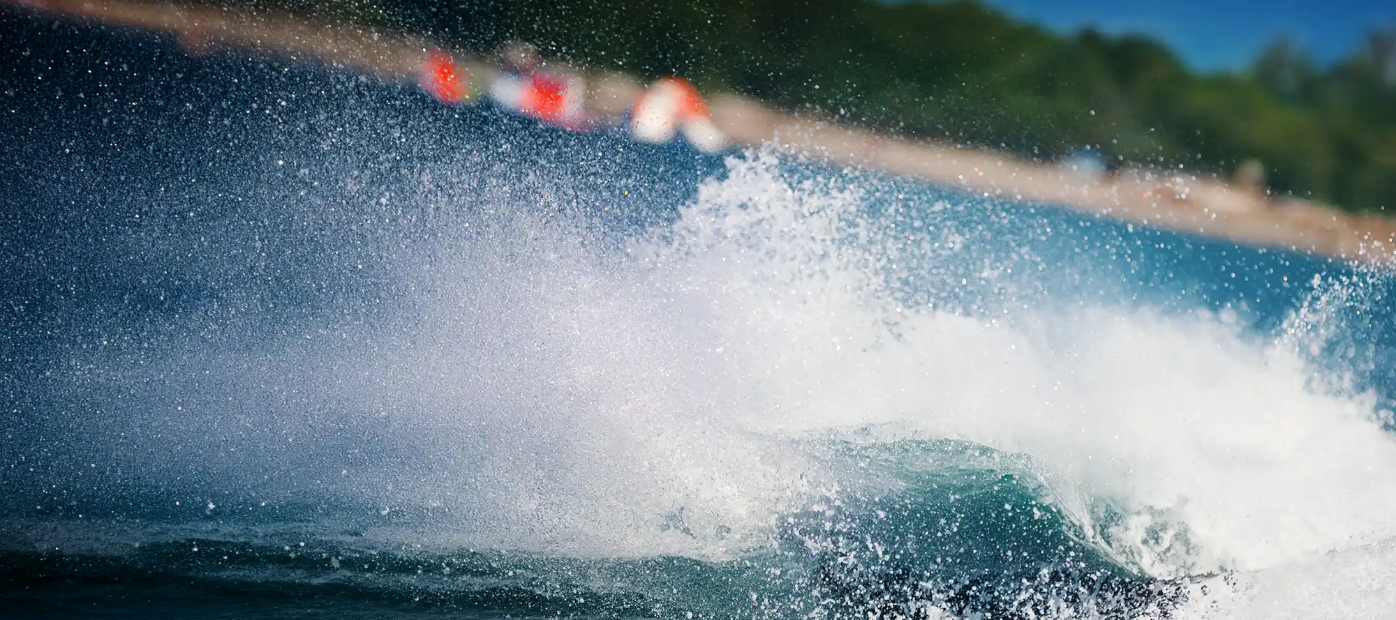 Jet ski wake spraying across a lake