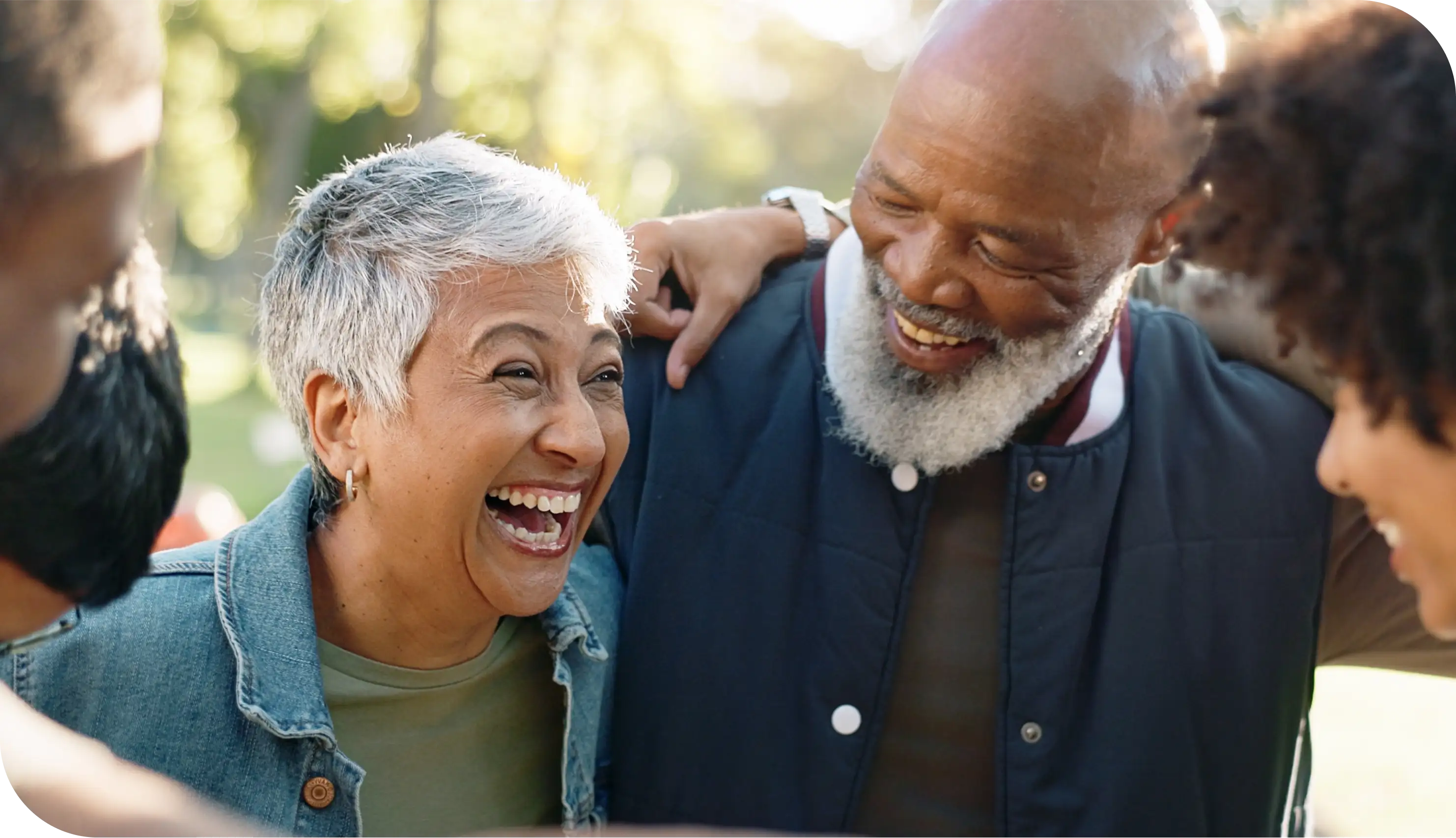 Happy senior couple laughing together outdoors, symbolizing active lifestyle and retirement security with Medicare Supplement Insurance.